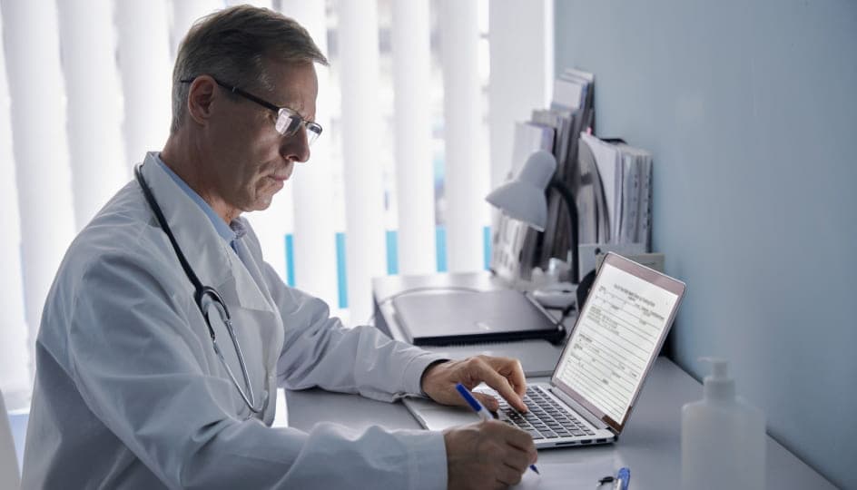 A medical worker writing a prescription
