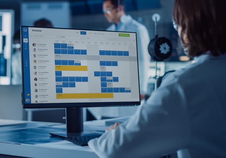 A medical worker utilizing healthcare software tools on a desktop