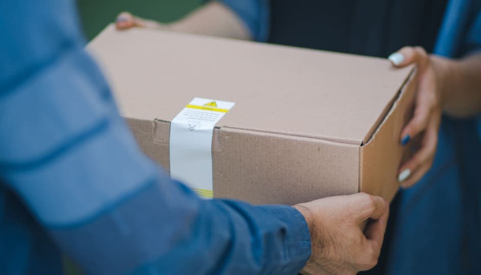 A courier completes the delivery of a box