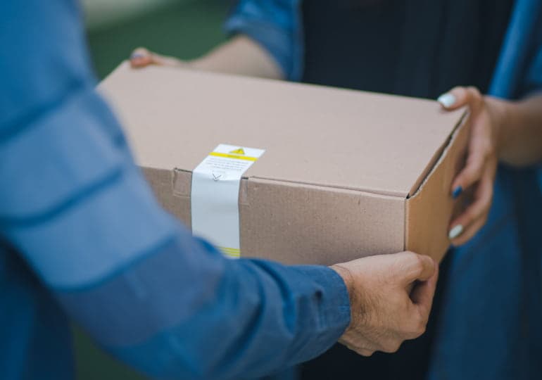 A courier completes the delivery of a box